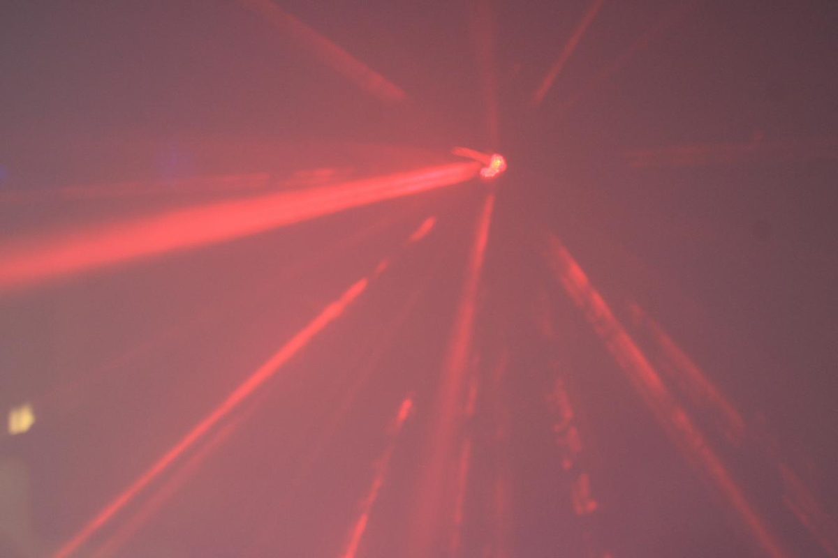 Red laser beams inside a party bus at night